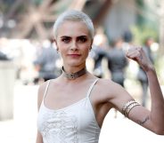 British model and actress Cara Delevingne poses during the photocall before Chanel 2017-2018 fall/winter Haute Couture collection show in Paris on July 4, 2017. / AFP PHOTO / Patrick KOVARIK (Photo credit should read PATRICK KOVARIK/AFP/Getty Images)