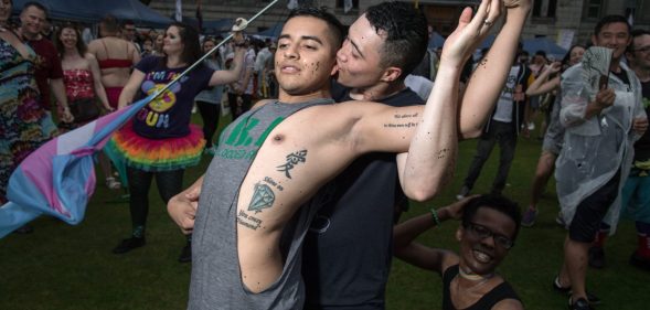 Participants pose for a photo during a 'Gay Pride' gathering in Seoul on July 15, 2017. Thousands of people celebrated gay rights with song, dance and a march in Seoul on July 15, amid rain and boisterous protests by conservative Christians. Religious South Koreans have been a loud fixture at the annual parade for years, holding a rival anti-homosexuality rally while trying to physically block the march. / AFP PHOTO / Ed JONES (Photo credit should read ED JONES/AFP/Getty Images)