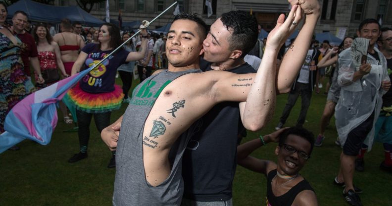 Participants pose for a photo during a 'Gay Pride' gathering in Seoul on July 15, 2017. Thousands of people celebrated gay rights with song, dance and a march in Seoul on July 15, amid rain and boisterous protests by conservative Christians. Religious South Koreans have been a loud fixture at the annual parade for years, holding a rival anti-homosexuality rally while trying to physically block the march. / AFP PHOTO / Ed JONES (Photo credit should read ED JONES/AFP/Getty Images)