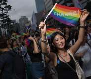 Participants march along a street during a 'Gay Pride' march in Seoul on July 15, 2017. Thousands of people celebrated gay rights with song, dance and a march in Seoul on July 15, amid rain and boisterous protests by conservative Christians. Religious South Koreans have been a loud fixture at the annual parade for years, holding a rival anti-homosexuality rally while trying to physically block the march. / AFP PHOTO / Ed JONES (Photo credit should read ED JONES/AFP/Getty Images)
