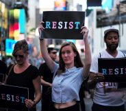 Protesters display placards against US President Donald Trump during a demonstration in front of the US Army career center in Times Square, New York, on July 26, 2017. Trump announced on July 26 that transgender people may not serve "in any capacity" in the US military, citing the "tremendous medical costs and disruption" their presence would cause. / AFP PHOTO / Jewel SAMAD (Photo credit should read JEWEL SAMAD/AFP/Getty Images)