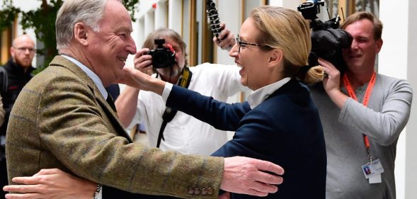 Alexander Gauland (L) and Alice Weidel, both top candidates of Germany's nationalist Alternative for Germany (AfD) party, hug prior to a press conference in Berlin on September 25, 2017, one day after general elections. The election spelt a breakthrough for the anti-Islam Alternative for Germany (AfD), which with 12.6 percent became the third strongest party and vowed to "go after" chancellor Angela Merkel over her migrant and refugee policy. / AFP PHOTO / Tobias SCHWARZ (Photo credit should read TOBIAS SCHWARZ/AFP/Getty Images)