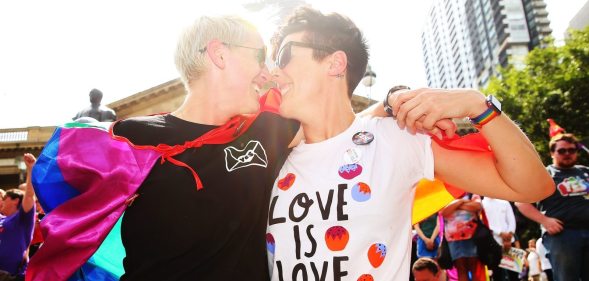 MELBOURNE, AUSTRALIA - NOVEMBER 15: Rebecca Davies and her partner Paula Van Bruggen kiss as they celebrate in the crowd as the result is announced during the Official Melbourne Postal Survey Result Announcement at the State Library of Victoria on November 15, 2017 in Melbourne, Australia. Australians have voted for marriage laws to be changed to allow same-sex marriage, with the Yes vote defeating No. Despite the Yes victory, the outcome of Australian Marriage Law Postal Survey is not binding, and the process to change current laws will move to the Australian Parliament in Canberra. (Photo by Scott Barbour/Getty Images)