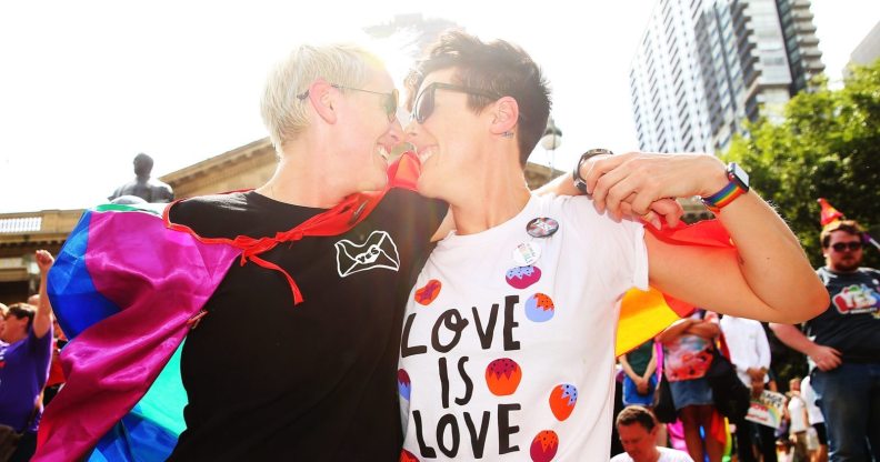 MELBOURNE, AUSTRALIA - NOVEMBER 15: Rebecca Davies and her partner Paula Van Bruggen kiss as they celebrate in the crowd as the result is announced during the Official Melbourne Postal Survey Result Announcement at the State Library of Victoria on November 15, 2017 in Melbourne, Australia. Australians have voted for marriage laws to be changed to allow same-sex marriage, with the Yes vote defeating No. Despite the Yes victory, the outcome of Australian Marriage Law Postal Survey is not binding, and the process to change current laws will move to the Australian Parliament in Canberra. (Photo by Scott Barbour/Getty Images)