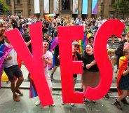 MELBOURNE, AUSTRALIA - NOVEMBER 15: People in the crowd celebrate as the result is announced during the Official Melbourne Postal Survey Result Announcement at the State Library of Victoria on November 15, 2017 in Melbourne, Australia. Australians have voted for marriage laws to be changed to allow same-sex marriage, with the Yes vote defeating No. Despite the Yes victory, the outcome of Australian Marriage Law Postal Survey is not binding, and the process to change current laws will move to the Australian Parliament in Canberra. (Photo by Scott Barbour/Getty Images)