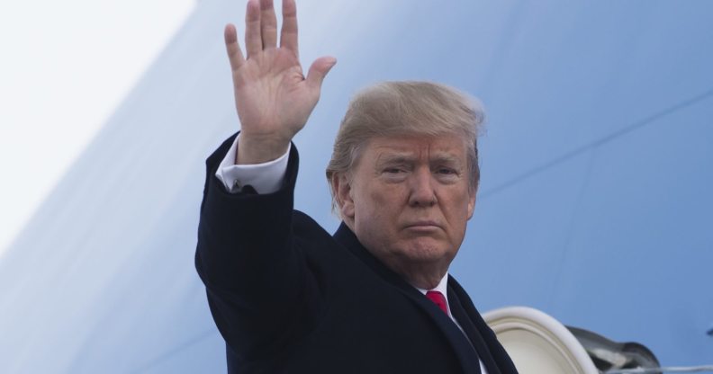 US President Donald Trump waves from Air Force One prior to departure from Andrews Air Force Base in Maryland, December 4, 2017, as Trump travels to Salt Lake City, Utah. / AFP PHOTO / SAUL LOEB (Photo credit should read SAUL LOEB/AFP/Getty Images)