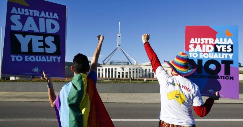 Equality ambassadors and volunteers from the Equality Campaign celebrate as they gather in front of Parliament House in Canberra on December 7, 2017, ahead of the parliamentary vote on Same Sex Marriage, which will take place later today in the House of Representatives. / AFP PHOTO / SEAN DAVEY