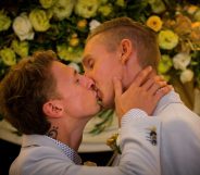 Australian Commonwealth Games sprinter Craig Burns (R) and fiance Luke Sullivan (L) kiss after exchanging vows at their marriage ceremony at Summergrove Estate, New South Wales on January 9, 2018. Australia officially become the 26th country to legalise same-sex marriage after the law was passed on December 9, 2017, with the overwhelming backing of the Federal Parliament. / AFP PHOTO / Patrick HAMILTON (Photo credit should read