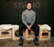 Singer Dan Reynolds sits on a box.