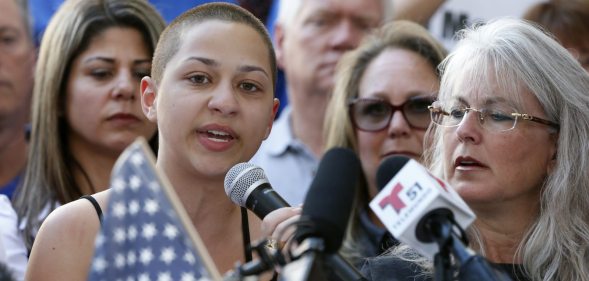 Marjory Stoneman Douglas High School student Emma Gonzalez is hugged by a friend following her speech at a rally for gun control at the Broward County Federal Courthouse in Fort Lauderdale, Florida on February 17, 2018. A former student, Nikolas Cruz, opened fire at the high school leaving 17 people dead and 15 injured on February 14. / AFP PHOTO / RHONA WISE (Photo credit should read RHONA WISE/AFP/Getty Images)
