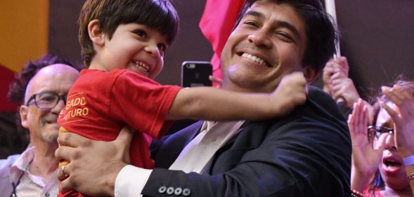Presidential candidate of the ruling Citizens' Action Party (PAC), Carlos Alvarado, picks up his son Gabriel, during a campaign rally in San Jose, Costa Rica, on March 24, 2018. / AFP PHOTO / Ezequiel BECERRA (Photo credit should read EZEQUIEL BECERRA/AFP/Getty Images)