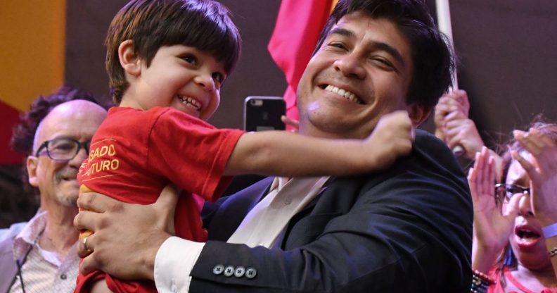 Presidential candidate of the ruling Citizens' Action Party (PAC), Carlos Alvarado, picks up his son Gabriel, during a campaign rally in San Jose, Costa Rica, on March 24, 2018. / AFP PHOTO / Ezequiel BECERRA (Photo credit should read EZEQUIEL BECERRA/AFP/Getty Images)