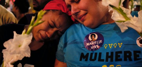Women react at a march while mourning activist Marielle Franco in Rio de Janeiro on April 14, 2018, one month after her murder in Lapa. The murder of Franco, a black Brazilian activist who fought her way out of the slums to become a popular councilor, made headlines around the world. The outspoken 38-year-old, who was a critic of police brutality, an advocate for minorities and the posterchild of a new type of politics, was shot dead on March 14 in an assassination-style killing with four bullets to the head. / AFP PHOTO / DIEGO HERCULANO (Photo credit should read DIEGO HERCULANO/AFP/Getty Images)