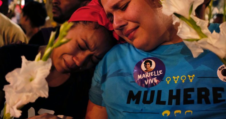 Women react at a march while mourning activist Marielle Franco in Rio de Janeiro on April 14, 2018, one month after her murder in Lapa. The murder of Franco, a black Brazilian activist who fought her way out of the slums to become a popular councilor, made headlines around the world. The outspoken 38-year-old, who was a critic of police brutality, an advocate for minorities and the posterchild of a new type of politics, was shot dead on March 14 in an assassination-style killing with four bullets to the head. / AFP PHOTO / DIEGO HERCULANO (Photo credit should read DIEGO HERCULANO/AFP/Getty Images)