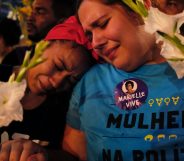 Women react at a march while mourning activist Marielle Franco in Rio de Janeiro on April 14, 2018, one month after her murder in Lapa. The murder of Franco, a black Brazilian activist who fought her way out of the slums to become a popular councilor, made headlines around the world. The outspoken 38-year-old, who was a critic of police brutality, an advocate for minorities and the posterchild of a new type of politics, was shot dead on March 14 in an assassination-style killing with four bullets to the head. / AFP PHOTO / DIEGO HERCULANO (Photo credit should read DIEGO HERCULANO/AFP/Getty Images)