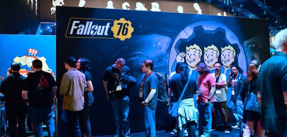 Gaming fans wait in line for freebies from Bethesda's Fallout 76 game.