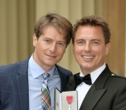 John Barrowman with his husband, Scott Gill, at Buckingham Palace