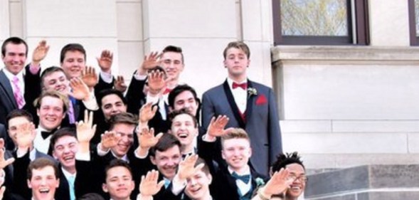 Jordan Blue stands defiant as many of his classmates do a 'mass Nazi salute'