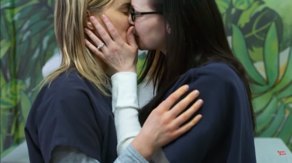 Piper Chapman (L) played by Taylor Schilling, kisses Alex Vause (R) played by Laura Prepon in Orange Is The New Black