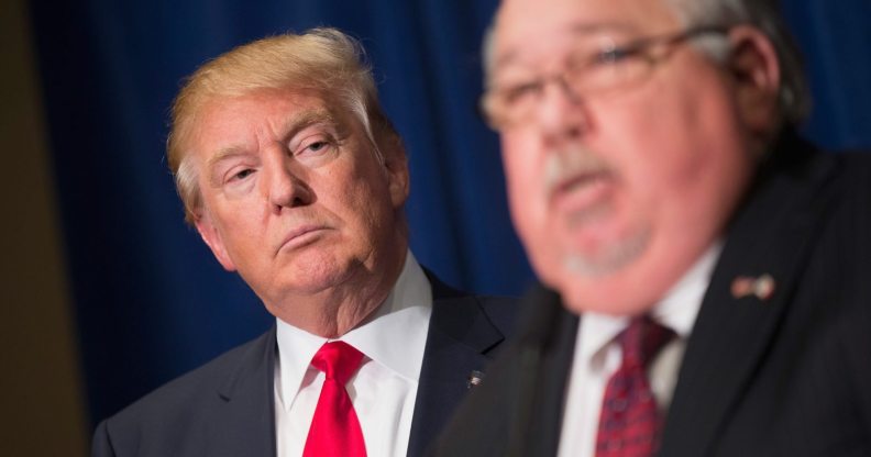 DUBUQUE, IA - AUGUST 25: Republican presidential candidate Donald Trump (L) listens as Sam Clovis speaks at a press conference at the Grand River Center on August 25, 2015 in Dubuque, Iowa. Clovis recently quit his position as Iowa campaign chairman for Rick Perry. Trump leads most polls in the race for the Republican presidential nomination. (Photo by Scott Olson/Getty Images)