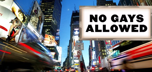 Times Square in New York City, alongside a sign that says 'No Gays Allowed'