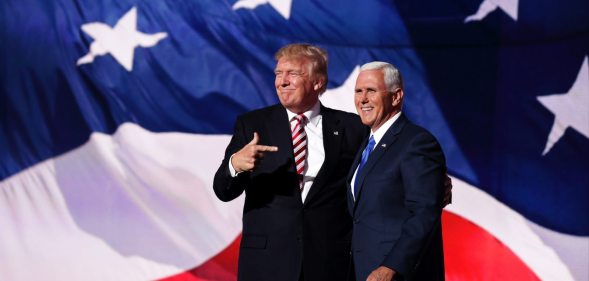 CLEVELAND, OH - JULY 20: Republican presidential candidate Donald Trump stand with Republican vice presidential candidate Mike Pence and acknowledge the crowd on the third day of the Republican National Convention on July 20, 2016 at the Quicken Loans Arena in Cleveland, Ohio. Republican presidential candidate Donald Trump received the number of votes needed to secure the party's nomination. An estimated 50,000 people are expected in Cleveland, including hundreds of protesters and members of the media. The four-day Republican National Convention kicked off on July 18. (Photo by Chip Somodevilla/Getty Images)
