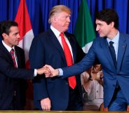 Mexico's President Enrique Pena Nieto shakes hands with Canadian Prime Minister Justin Trudeau next to US President Donald Trump after signing the USMCA agreement