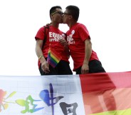 A gay couple kiss at an anti-discrimination parade in Chine, where a writer was recently jailed for including gay sex scenes in her novel.