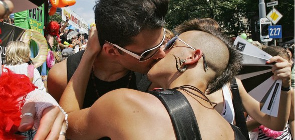 A couple kiss as they take part in a "Regenbogenparade" (Rainbow Parade) with thousands of lesbians, gays, bisexuals and transgender individuals, to ask the Austrian government for equal rights for gay relationships on July 4, 2009, in Vienna. (Getty)
