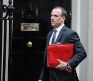 Dominc Raab carrying a red ministerial box