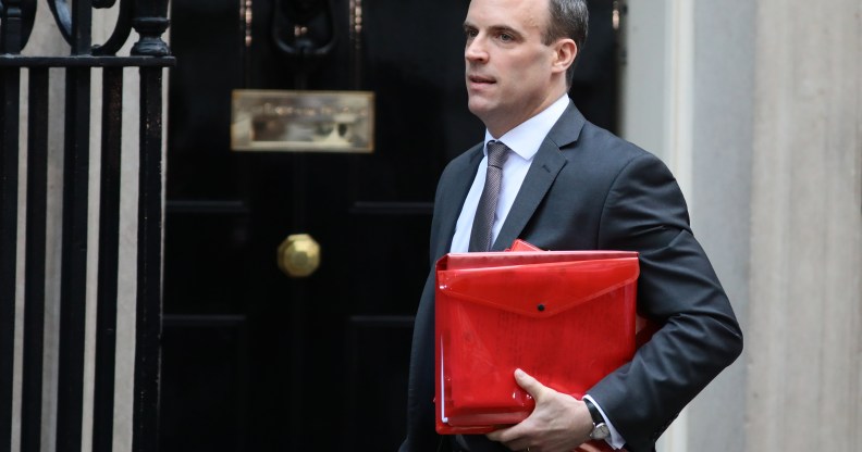 Dominc Raab carrying a red ministerial box