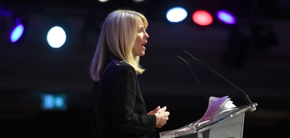 Esther McVey speaking at a podium