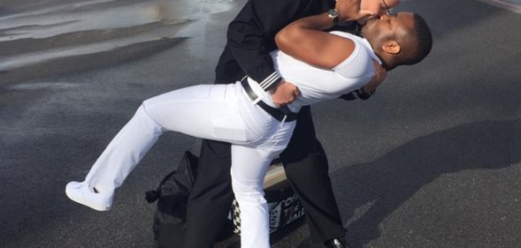 Bryan Woodington and Kenneth Woodington kissing after Bryan gets back from seven months in the Middle East on the USS The Sullivans