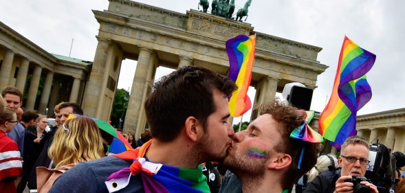 TOPSHOT - Two men kiss as they attend a rally of gays and lesbians in front of the Brandenburg Gate in Berlin on June 30, 2017. The German parliament legalised same-sex marriage, days after Chancellor Angela Merkel said she would allow her conservative lawmakers to follow their conscience in the vote. / AFP PHOTO / Tobias SCHWARZ (Photo credit should read TOBIAS SCHWARZ/AFP/Getty Images)