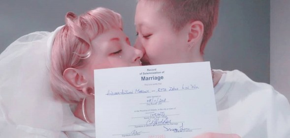 Jackie Chan's daughter Etta Ng and Andi Autumn pose with their wedding certificate