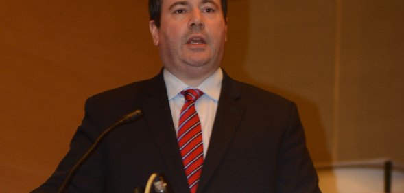 Jason Kenney speaking into a microphone