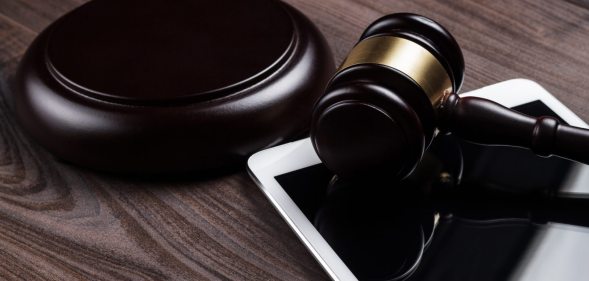 judge gavel and tablet computer on the table