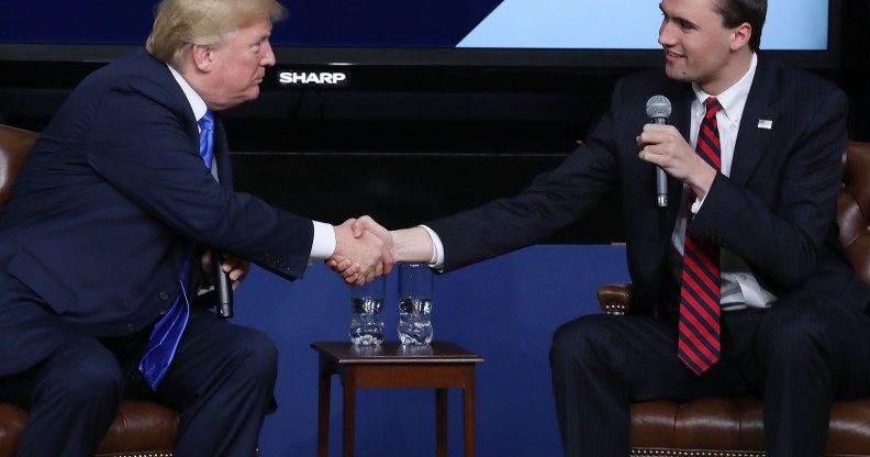 Image shows far right activist Charlie Kirk shaking hands with Donald Trump