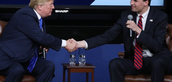 Image shows far right activist Charlie Kirk shaking hands with Donald Trump