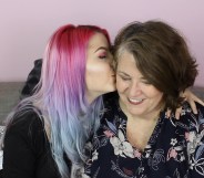 Lesbian couple Julia and Eileen kiss on the sofa