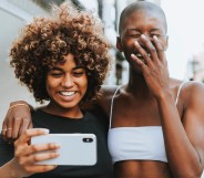 Two women smile while taking a photo of themselves