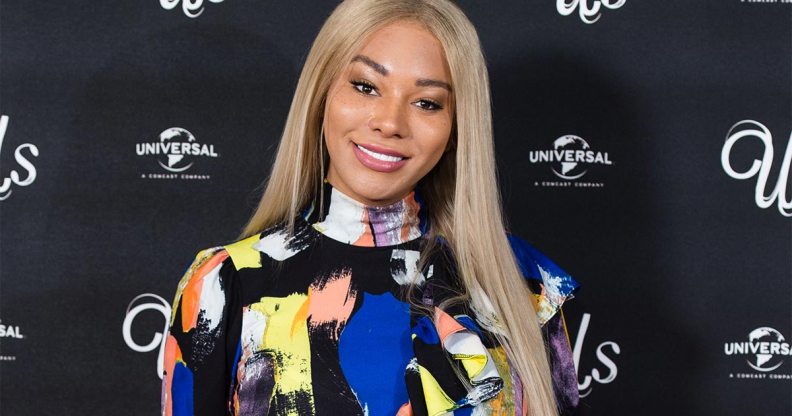 Munro Bergdord smiling in an abstract print dress