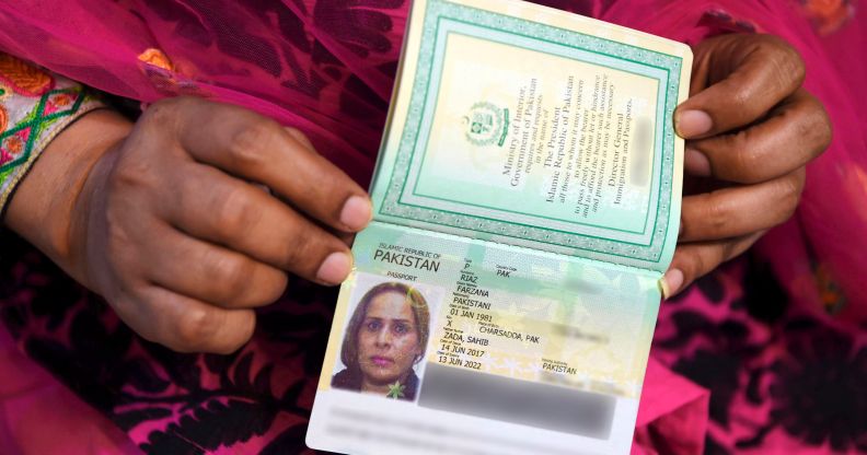 A close up of hands holding a non-binary passport.