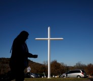 A silhouette against a white church cross