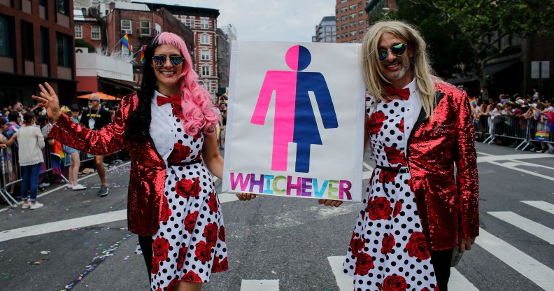 People holding up a Whichever gender sign