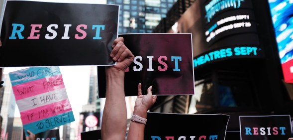 Dozens of protesters gather in Times Square near a military recruitment center to show their anger at President Donald Trump's decision to reinstate a ban on trans folk from serving in the militar. (Spencer Platt/Getty Images)