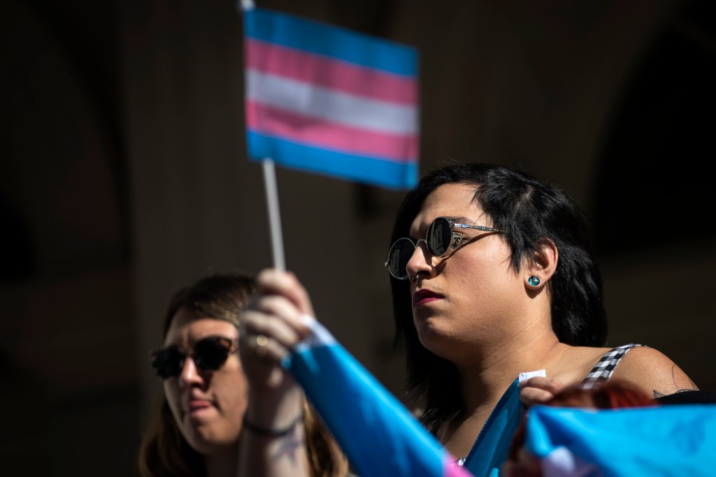 LGBT activists rally in support of transgender people on the steps of New York City Hall in October 2018