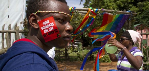 A Ugandan man with a sticker on his face takes part on August 9, 2014 in the annual gay pride in Entebbe, Uganda