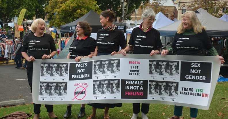 Women Speak Tasmania members holding a banner saying "female is not a feeling" and "sex not gender"