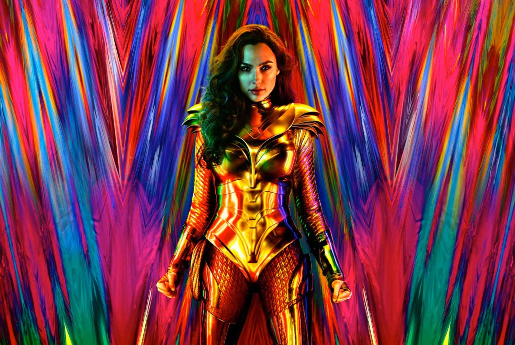 Gal Gadot as Wonder Woman in a gold suit in front of a multicoloured backdrop